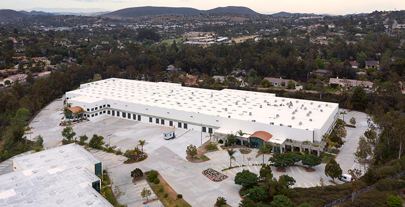 Image of a white building surrounded by trees