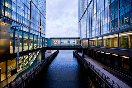 Two buildings connected by a glass bridge