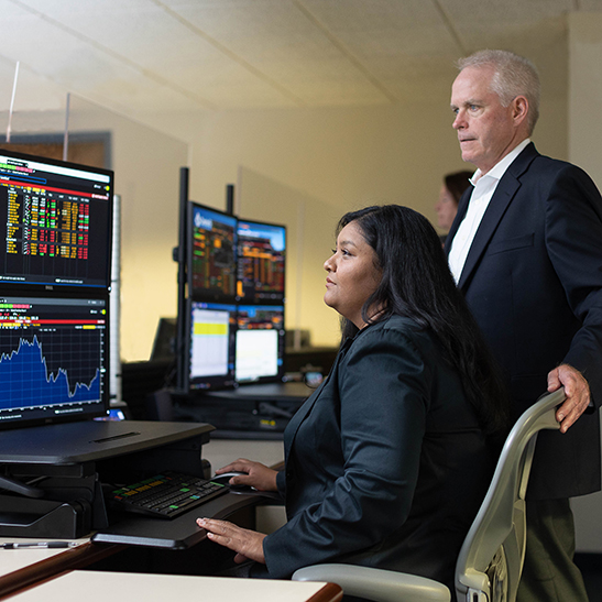 A man and a woman working with a computer